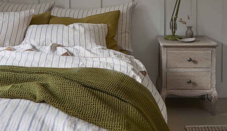Botanical Green Waffle Cotton Throw Blanket By Piglet in Bed